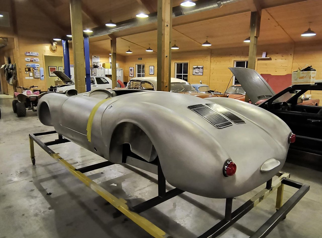 Hand-formed aluminium 550 Spyder body, front view with headlamps fitted
