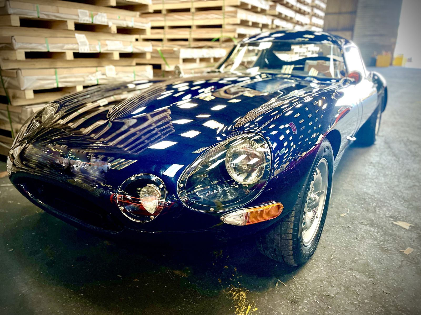Dark blue E-Type Re-Imagined, low angle in the workshop
