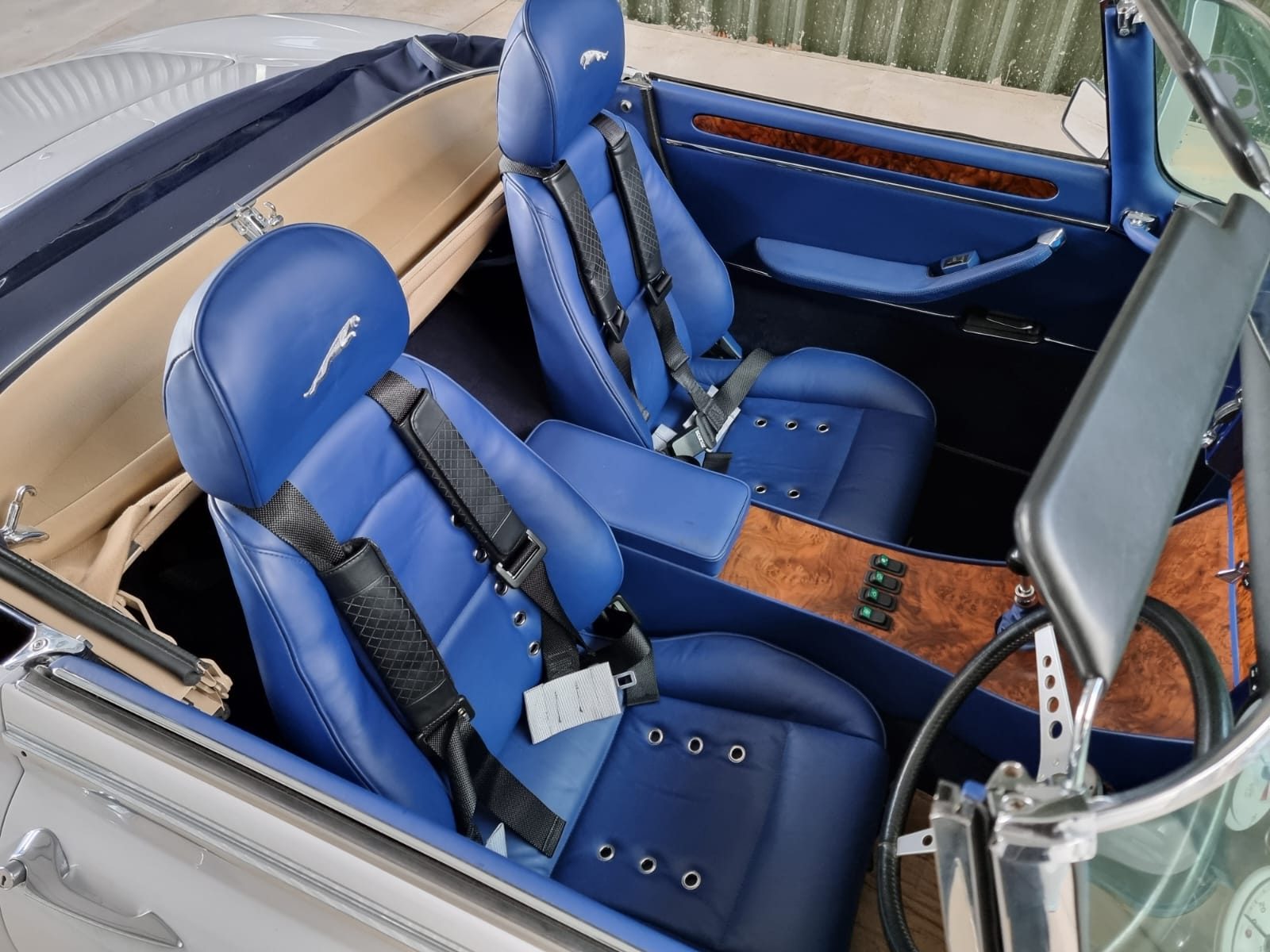 E-Type Re-Imagined — blue leather interior with black racing harnesses and burl walnut trim