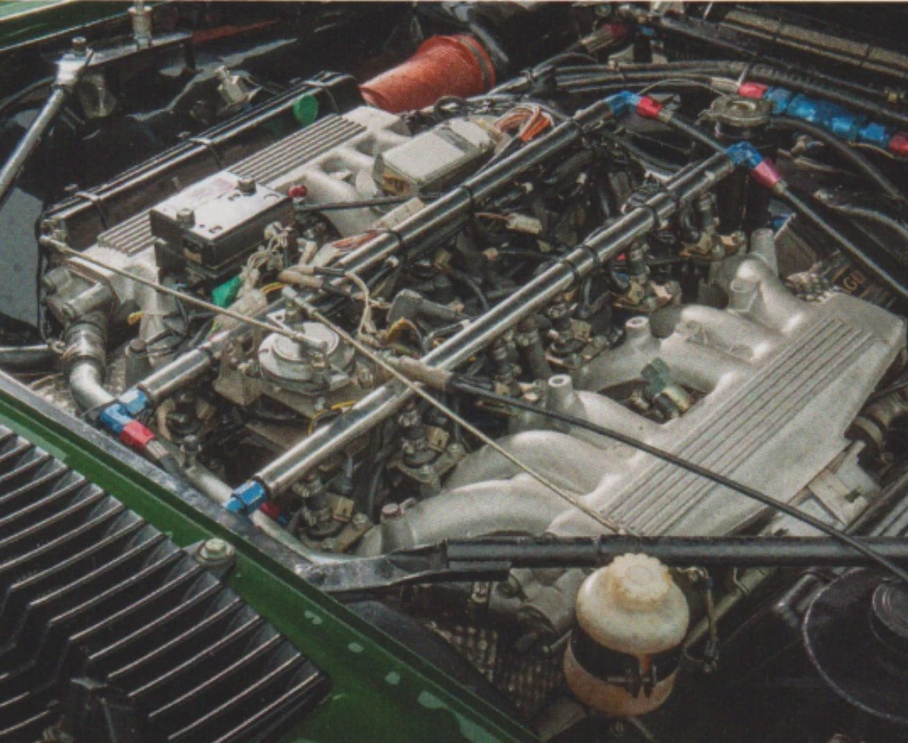 Under the bonnet: the 5.3-litre V12, its racing plenum and braided lines